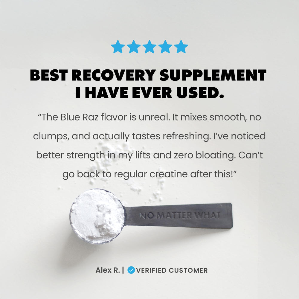 GAINS IN BULK blue raspberry creatine powder in a glass with clear solution.