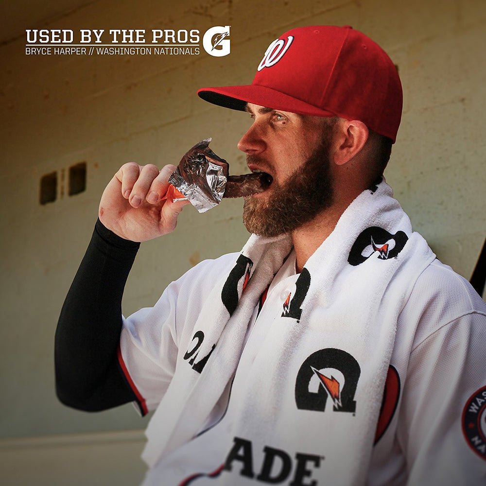 Athlete holds Gatorade Whey Protein Cookies and Creme bar during training