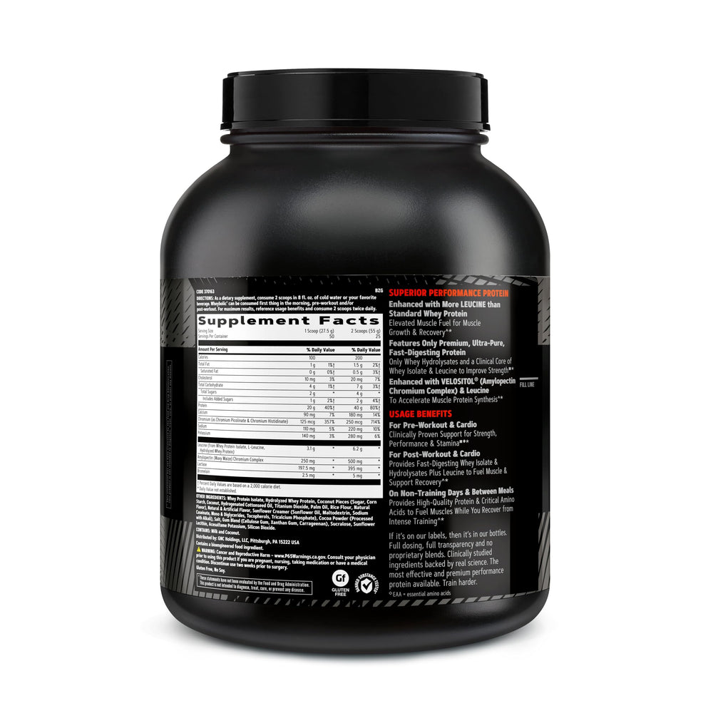 GNC AMP Wheybolic coconut caramel scoop beside bottle for easy mixing