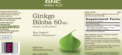 Person studying at a desk with GNC Herbal Plus Ginkgo Biloba for study focus.