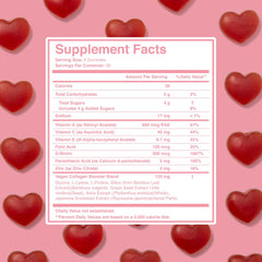 Grande Cosmetics gummy bottle with citrus flavor beside a glass of water for daily routine.
