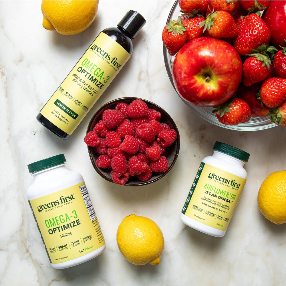Greens First Omega-3 Optimize with meals on a kitchen counter.