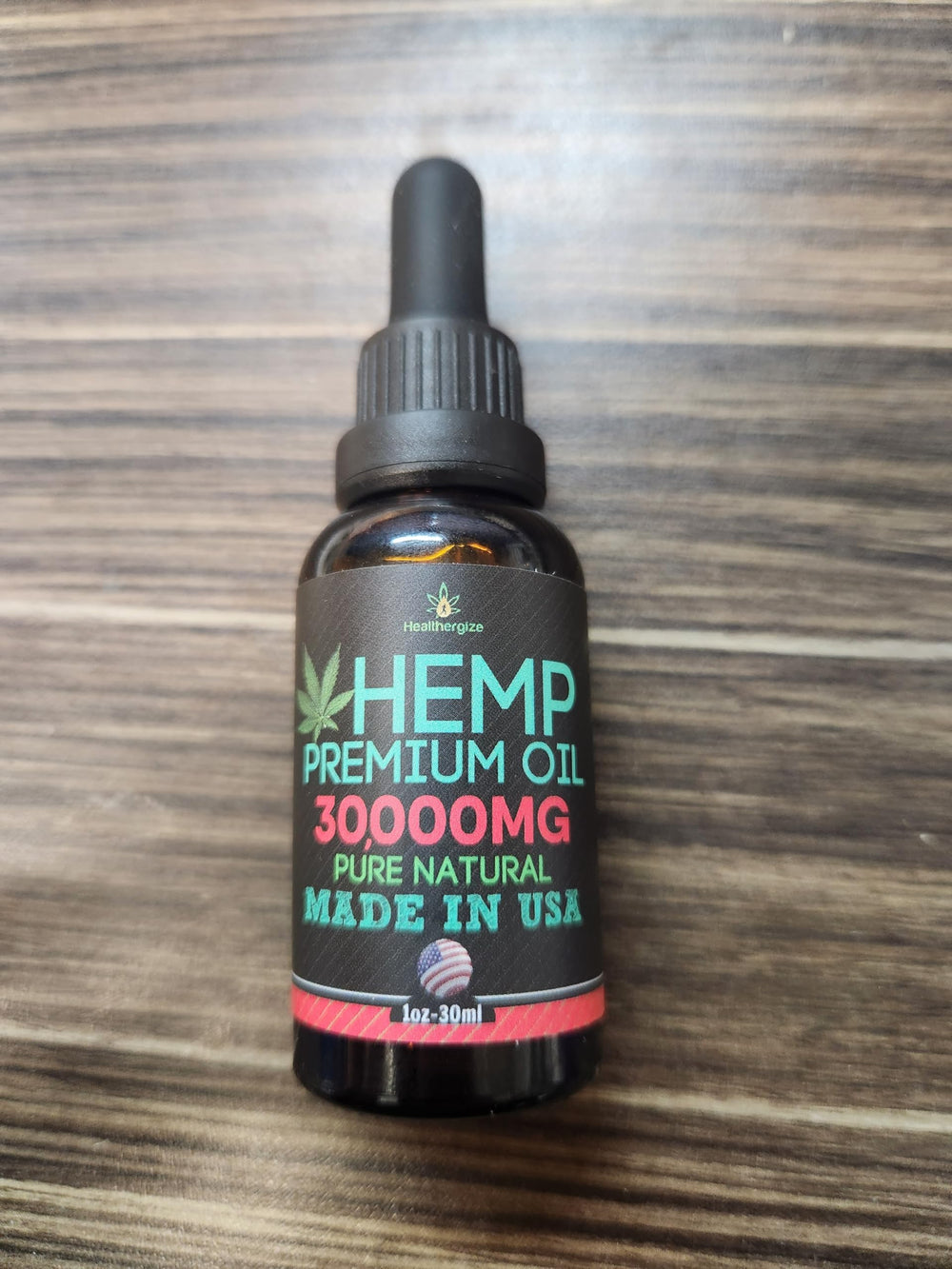 Healthergize hemp oil bottle close-up highlights natural omega nutrients.