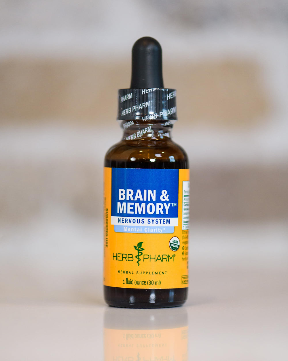 Herb Pharm Brain and Memory liquid vial ready for daily use on a kitchen counter.