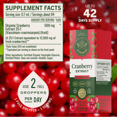 HERBAMAMA Cranberry Drops with glass of water for easy daily intake.