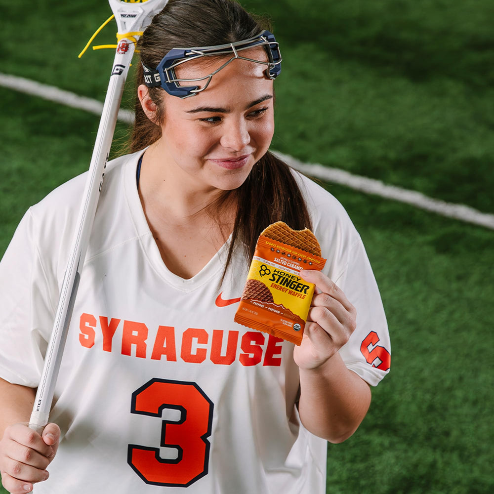 Athlete using Honey Stinger Organic Energy Waffle as on-the-go fuel