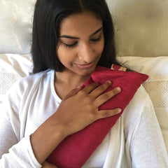 Hot Cherry pillow relaxing on a bed, showing versatile home use.
