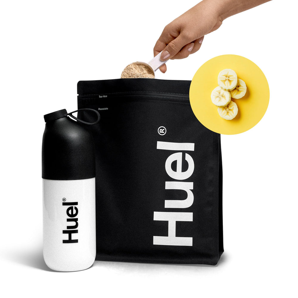 Measuring spoon next to Huel Black Edition banana tub for precise servings