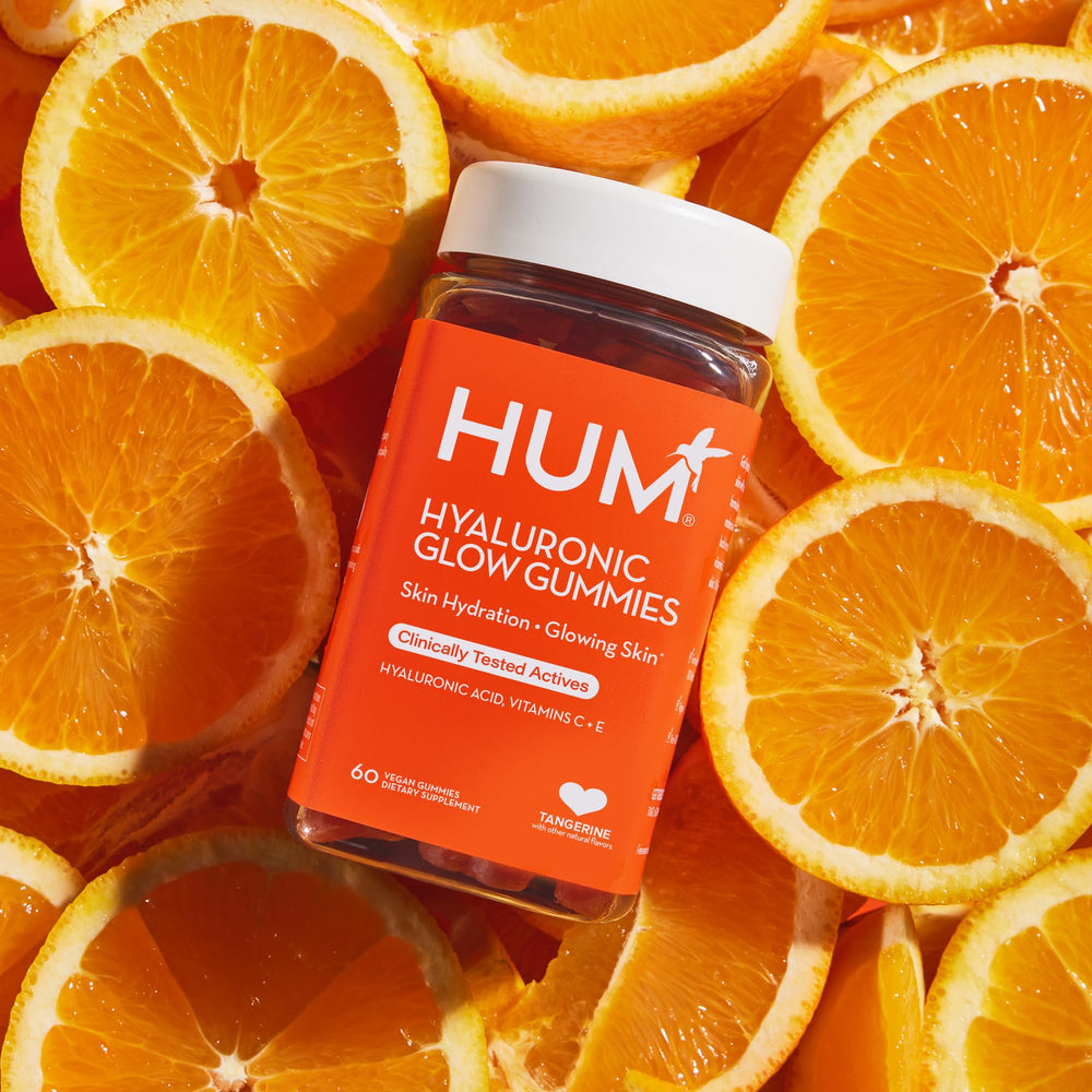 HUM Hyaluronic Glow bottle in a travel pouch signals easy travel use.