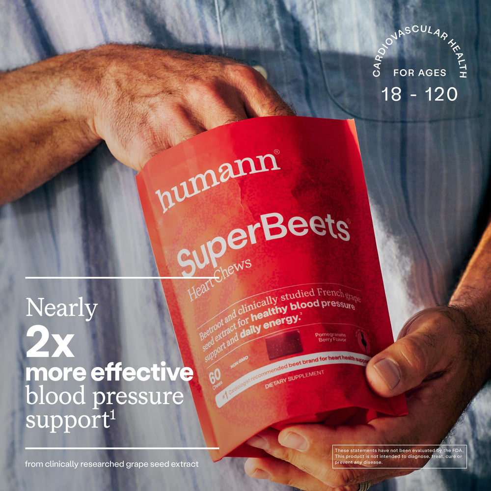 Hands holding Humann SuperBeets Heart Chews ready for convenient on-the-go support.