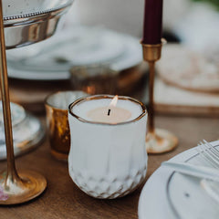 Hyggelight Astrid candle sits on a table creating a calming ambience.