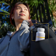 Integrative Therapeutics CoQ10 bottle on desk with glass of water