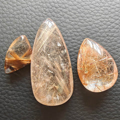 JDFlying rutilated quartz jewelry material sample highlighting dramatic inclusions.