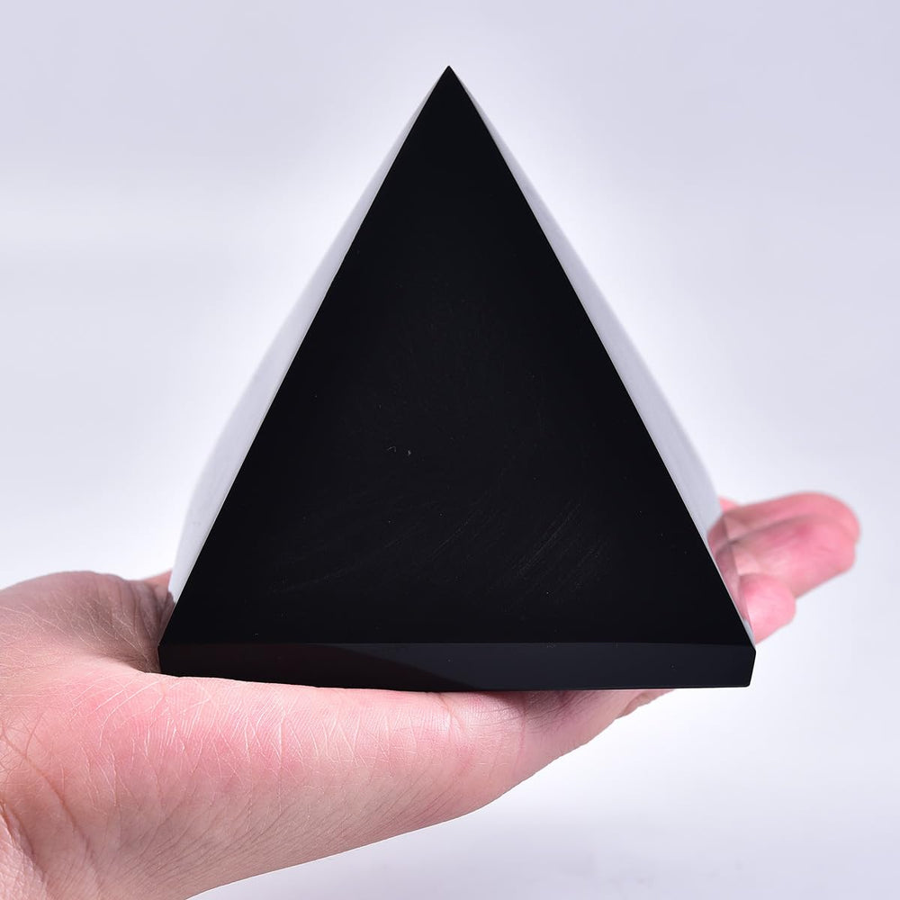 JIC Gem Black Obsidian Pyramid on a desk, creating a calm zen workspace.