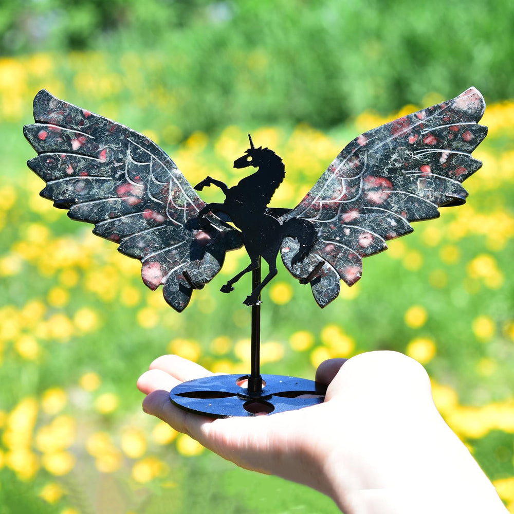 JIC Gem carved angel wings sit on the stand for elegant display.