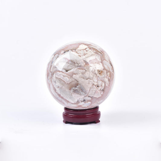 JIC Gem pink agate sphere on display stand for meditation and balance.