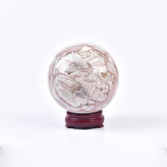 JIC Gem pink agate sphere on display stand for meditation and balance.