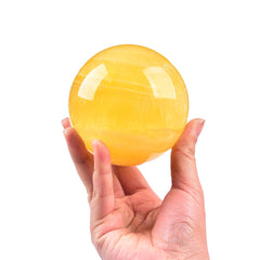 JIC Gem yellow fluorite ball close-up highlights vibrant color patterns.