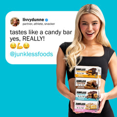 Junkless protein bar in hand demonstrates convenient snack between workouts.