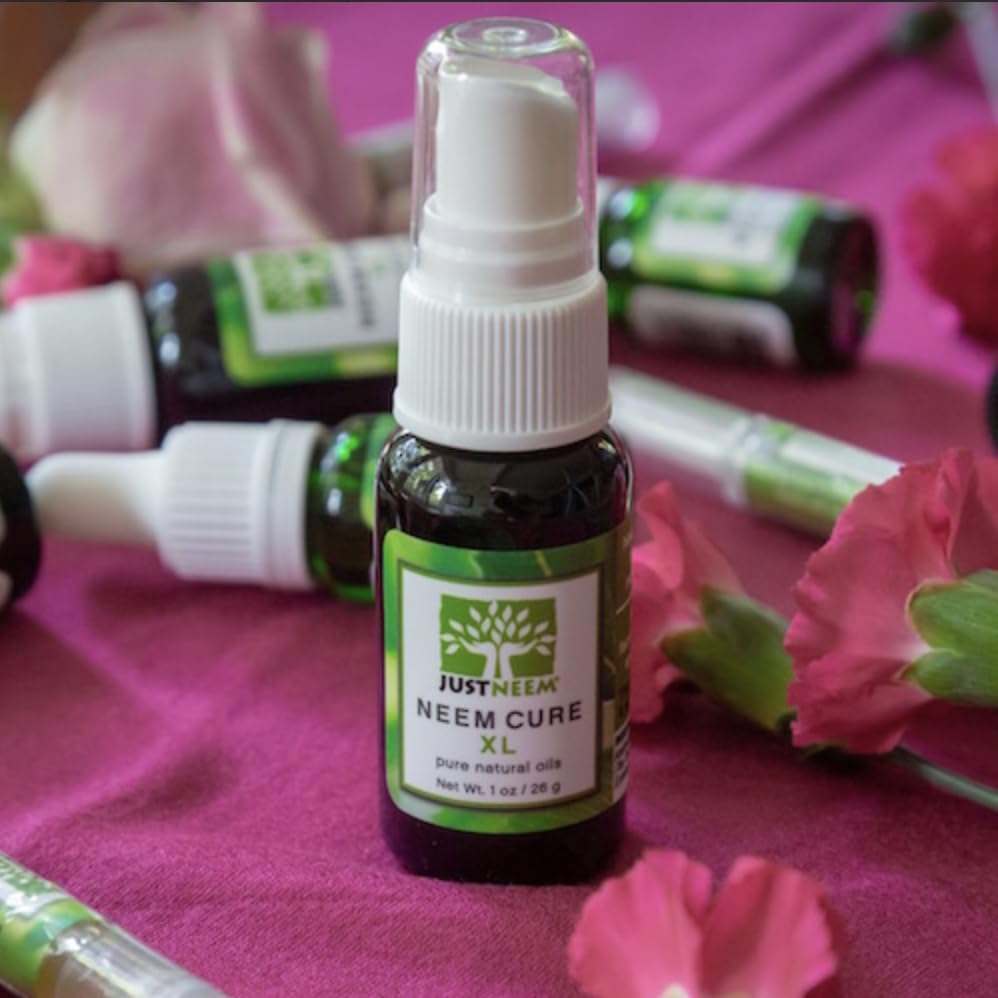 JustNeem Neem Cure Oil XL ingredient label featuring neem and jojoba oils.