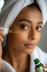 JustNeem Neem Cure Oil XL being applied to skin for soothing daily care.