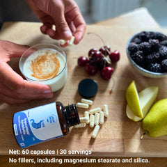 Layer Origin SuperHMO capsules in hand for on-the-go daily use.