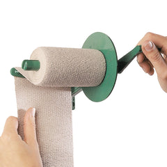 Lohmann & Rauscher Bandage Roller in use, guiding tension for a smoother bandage application