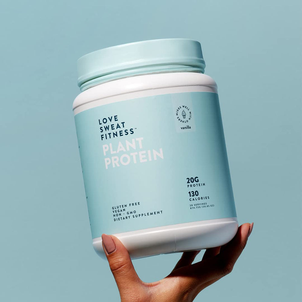 Pouring Love Sweat Fitness vanilla protein into a shaker bottle.