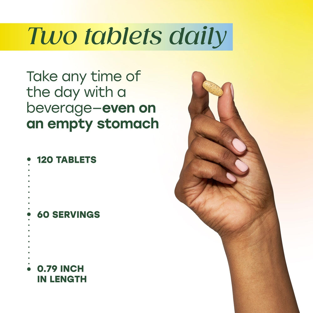 Pouring MegaFood multivitamin tablets to illustrate daily two-tablet regimen