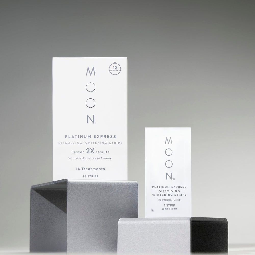 MOON travel essentials kit beside passport enables whitening on the go