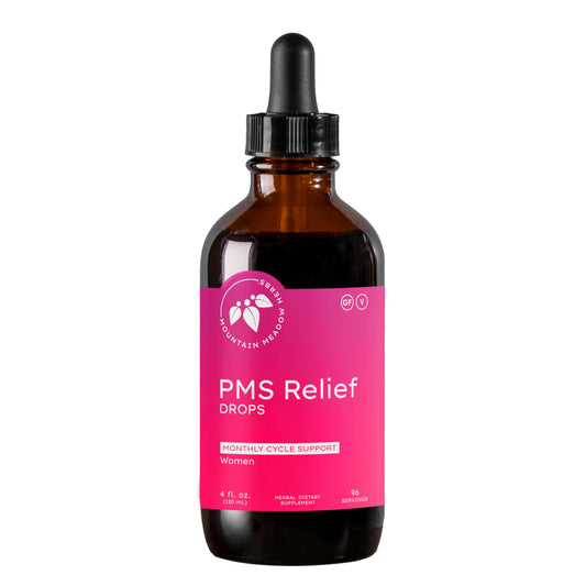 Mountain Meadow Herbs PMS Relief Drops bottle on wood surface for monthly balance.