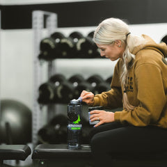 MTN OPS creatine powder pour action blending into a drink smoothly.