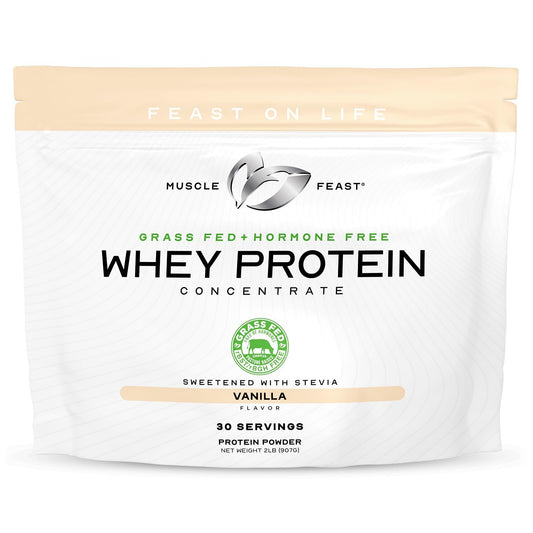 Muscle Feast grass-fed whey concentrate vanilla tub ready for a protein shake