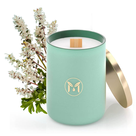 Myrrh Bliss of Essence Ocean Breeze candle in glass jar for relaxing living room ambiance.
