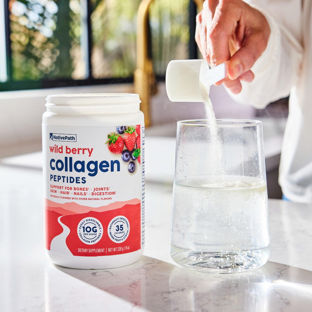 NativePath Wild Berry Collagen on the kitchen counter with fruit.