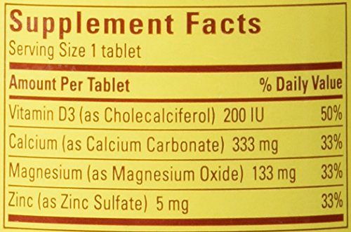 Nature Made Calcium Magnesium Zinc tabs label closeup, displays dosage for daily bone support.