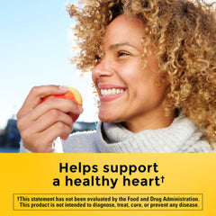 CholestOff Plus softgels in hand show an easy twice-daily routine with meals.