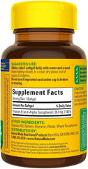 Nature Made bottle with lid off showing softgel capsules.