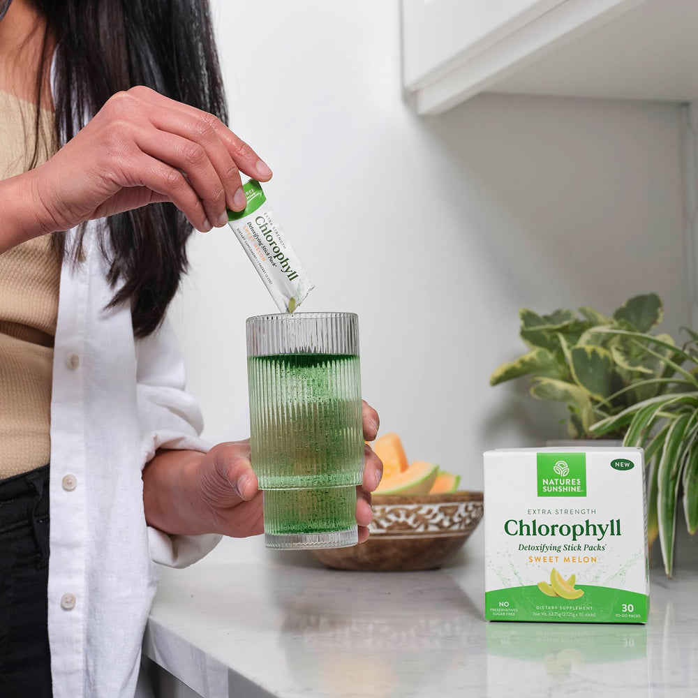 Glass with sweet melon chlorophyll drink made from Nature's Sunshine sticks.