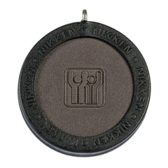 Nikken Kenko PowerChip Black front view, compact magnetic chip for daily wear.