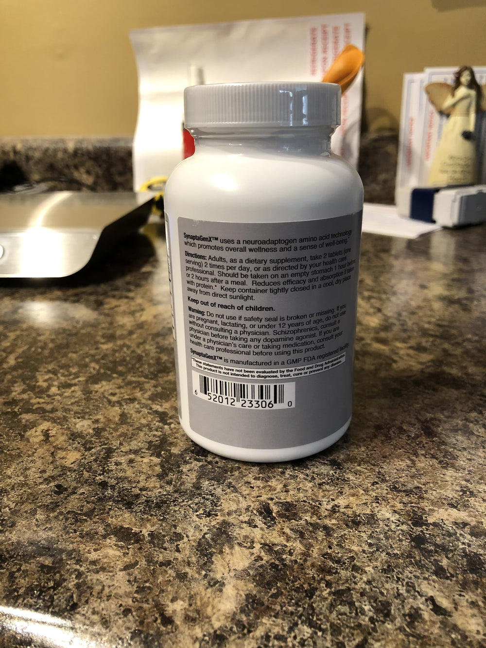 Lifestyle scene with SynaptaGenX bottle on a nightstand for mood balance