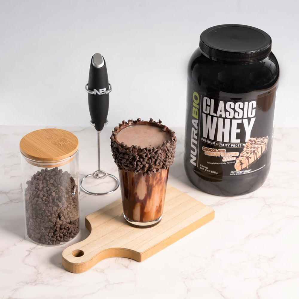 NutraBio Classic Whey scoop beside a glass ready for quick protein intake.