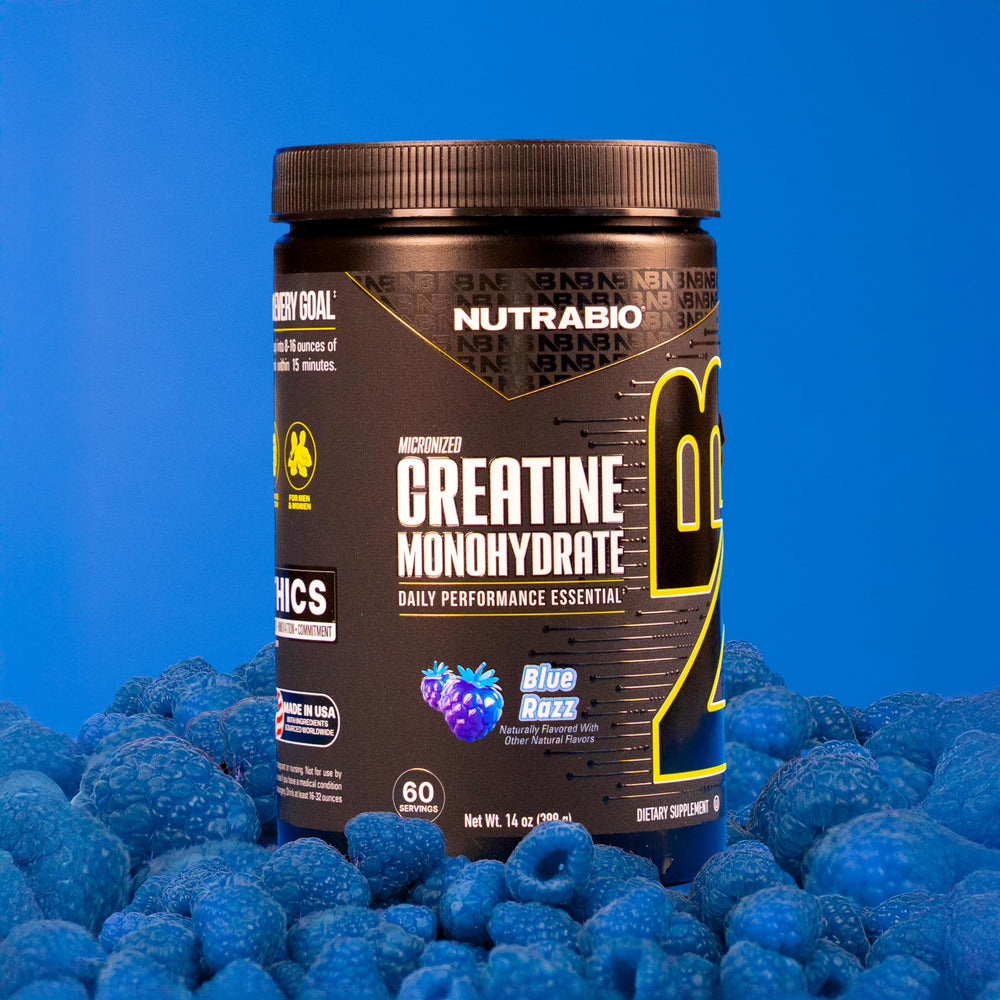 NutraBio Creatine Blue Razz powder in a glass ready for post-workout recovery.