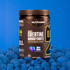 NutraBio Creatine Blue Razz powder in a glass ready for post-workout recovery.