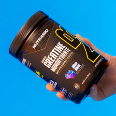 NutraBio Creatine Blue Razz shaker with powder for on the go training.
