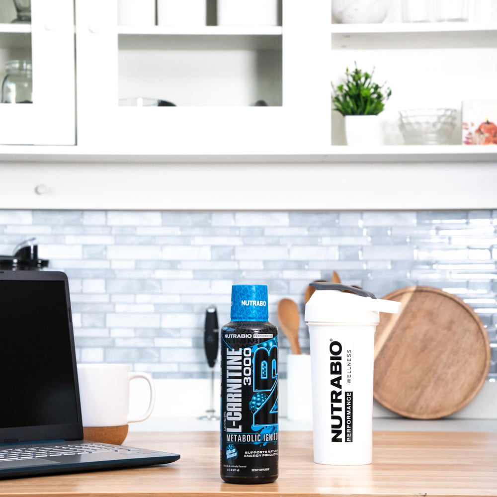 NutraBio L-Carnitine Liquid Shots glass serving showcases zero carbs and sugars per serving.