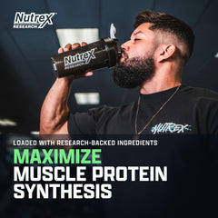 Nutrex EAA Hydration powder scoop beside a glass showing powder texture and mixability