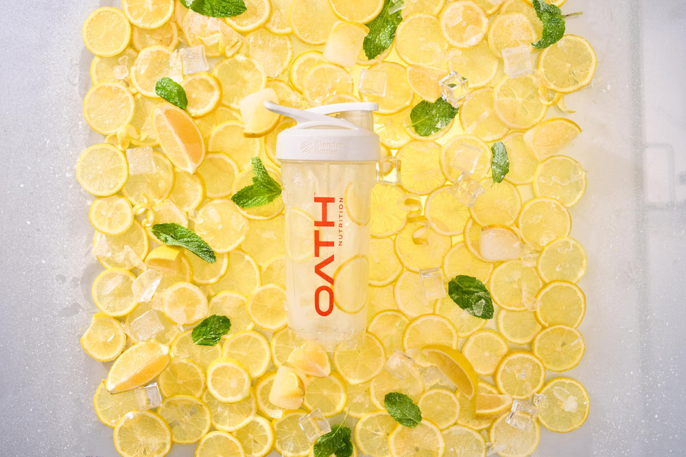 Oath Clear Whey Lemonade bottle beside sunny beach scene
