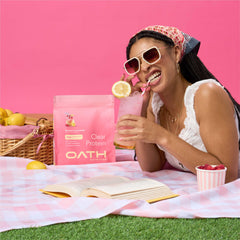 Oath Nutrition Clear Whey Raspberry Lemonade glass shot suggesting poolside protein enjoyment.