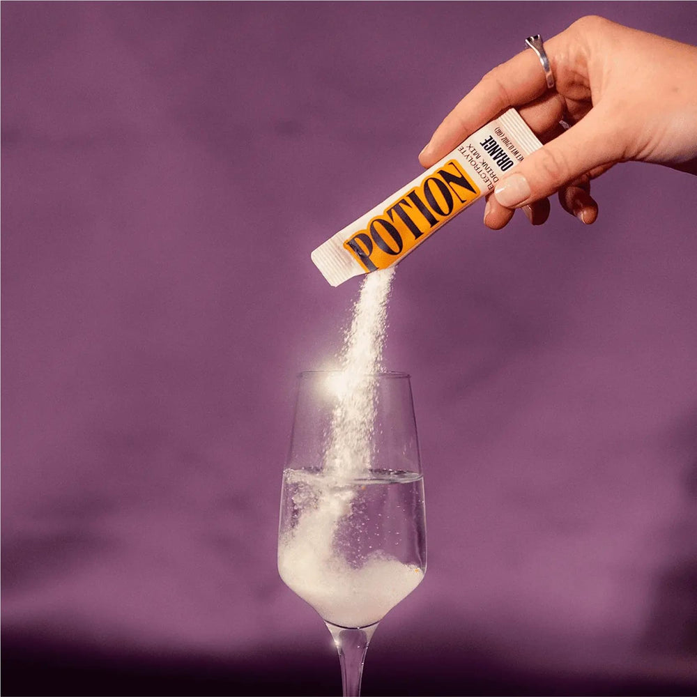 Potion Supernatural Hydration orange powder dissolving in ice-cold water after training